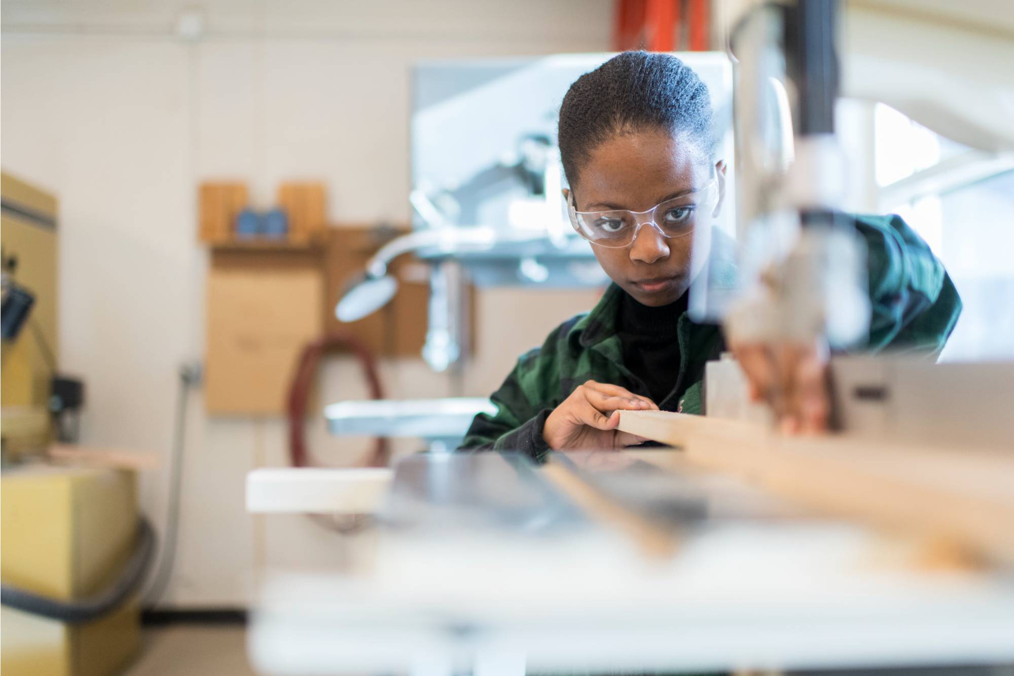 A students working on the band saw with concentration - focus